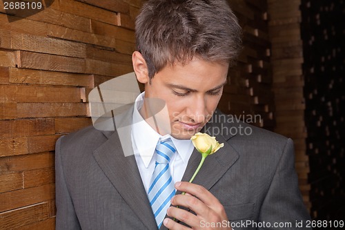 Image of Male Executive Holding Yellow Rose