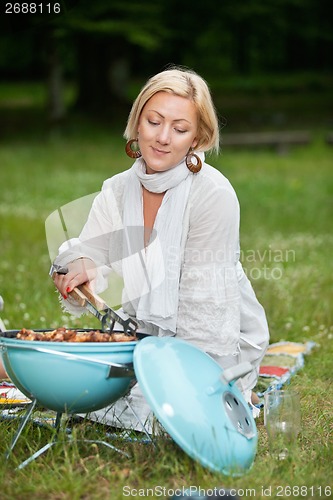 Image of Woman Preparing Food On Barbecue