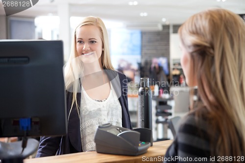 Image of Receptionist Helping Customer at Beauty Salon