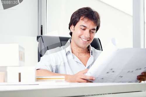Image of Happy Architect Looking at Blueprints