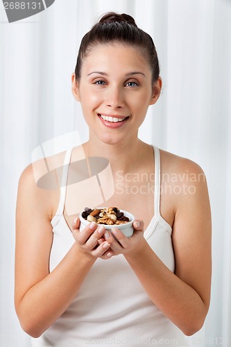 Image of Woman Holding Bowl Of Dry Fruits