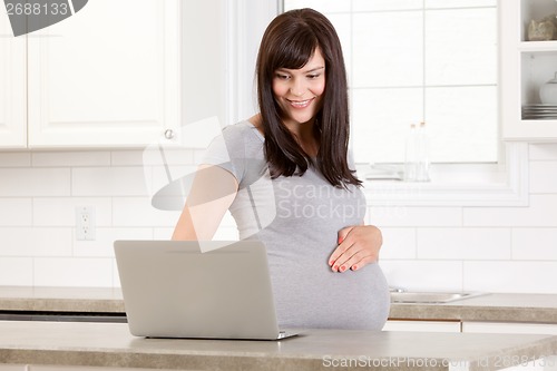 Image of Pregnant Woman Using Laptop Computer