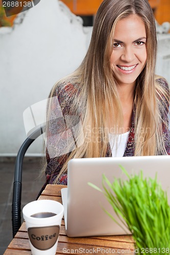 Image of Beautiful Woman With Laptop At Cafe