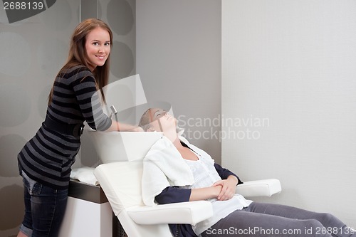 Image of Woman Receiving Hair Wash at Beauty Salon