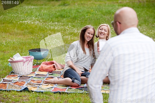 Image of Friends Taking Photos in Park