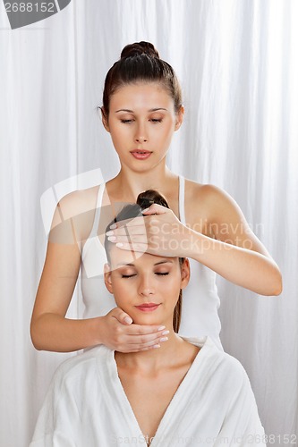 Image of Masseuse Giving Head Massage To Woman