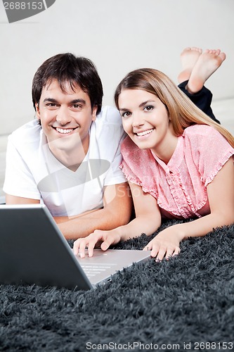 Image of Young Couple Using Laptop