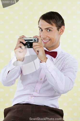 Image of Male Geek Holding Retro Camera