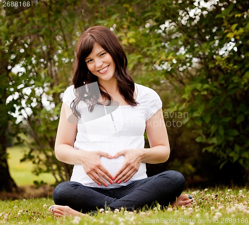 Image of Happy Smiling Pregnant Woman in Park