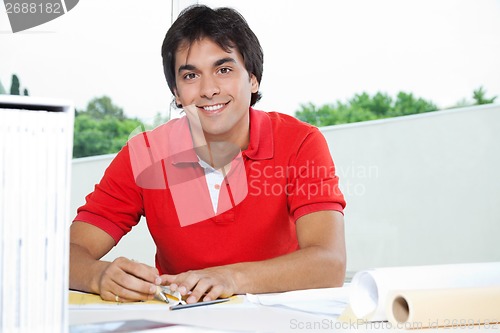 Image of Architect Working On Blueprint