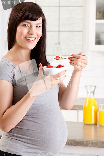 Image of Happy Pregnant Woman Eating Breakfast