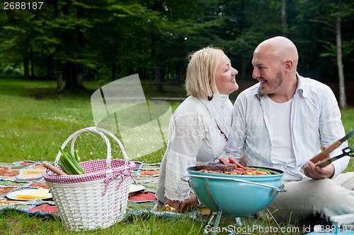 Image of Happy Couple in Park with Barbecue