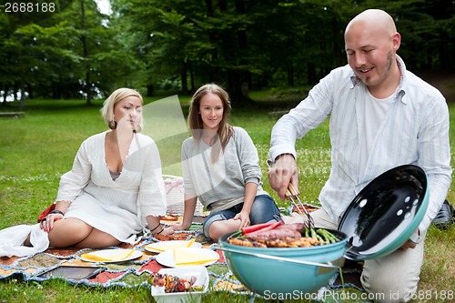 Image of Friends with BBQ picnic in Park