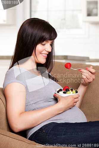 Image of Pregnant Woman Eating Fruit