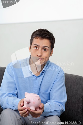 Image of Businessman With Piggybank