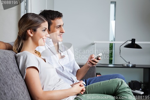 Image of Couple Sitting Together On Sofa