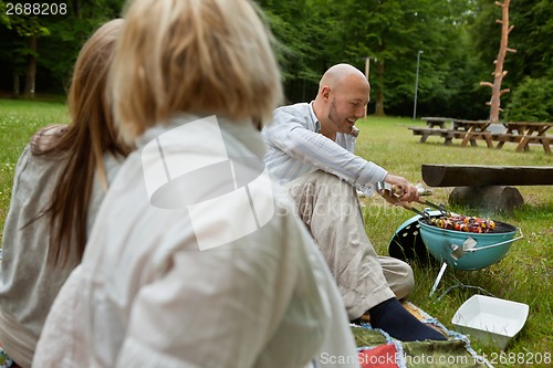 Image of Man Cooking Food On Barbecue