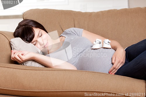 Image of Pregnant Mother Resting on Sofa