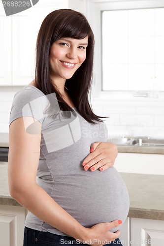 Image of Beautiful Pregnant Woman Holding Belly