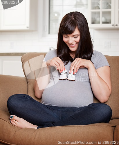 Image of Expecting Mother Holding Shoes