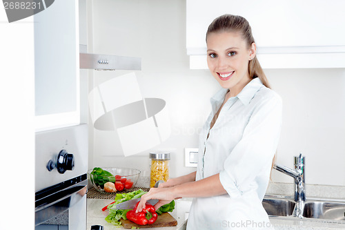 Image of Pretty Female Cutting Vegetables in Kitchen