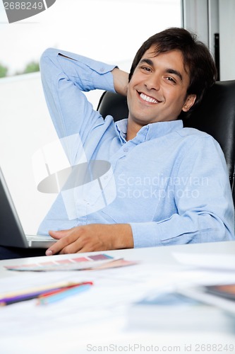Image of Relaxed Interior Designer With Laptop