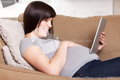 Image of Happy Pregnant Woman with Digital Tablet