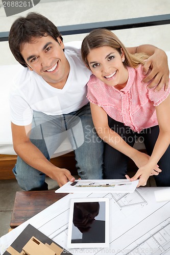 Image of Happy Couple With House Plan