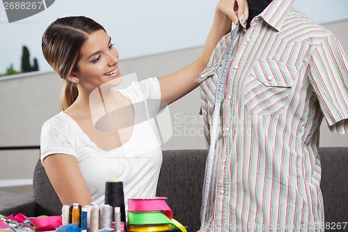 Image of Woman Taking Shirt's Measurement