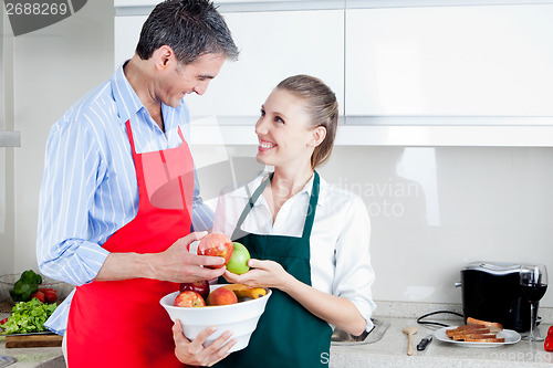 Image of Happy Couple in Kitchen Preparing Food
