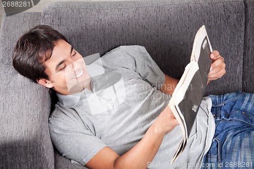Image of Young Man Reading newspaper