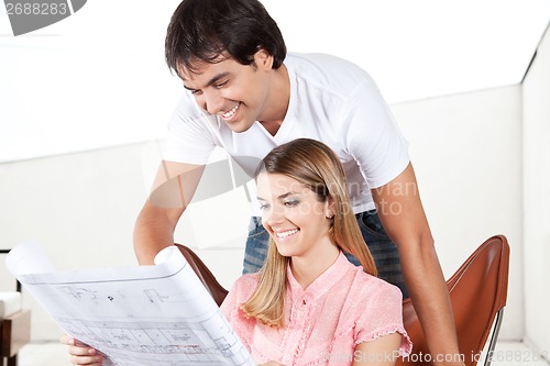 Image of Young Couple Looking at Blueprints