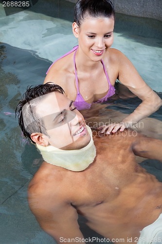 Image of Man In Pool with Beautiful Woman