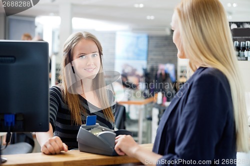 Image of Female Sales Clerk At Counter