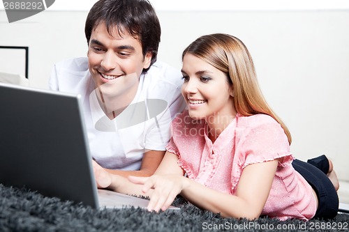 Image of Young Couple Using Laptop