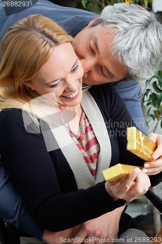 Image of Middle Aged Man Kissing Woman