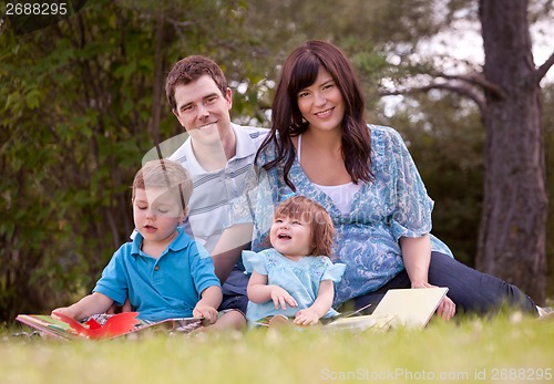 Image of Family Reading in Park