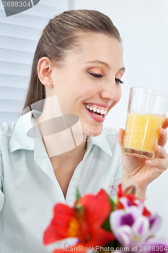 Image of Jovial Businesswoman Holding Orange Juice