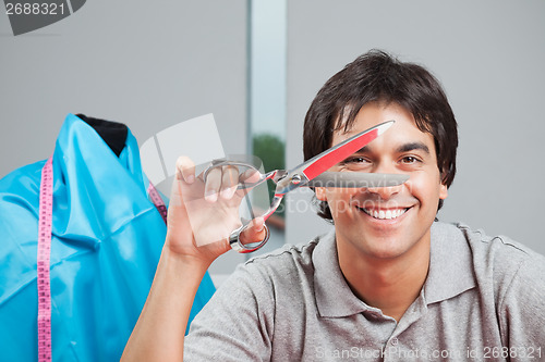 Image of Happy Dressmaker Holding Scissor