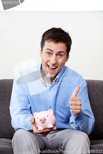 Image of Man with Piggy Bank