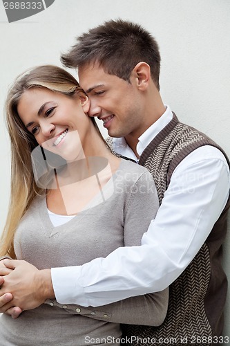 Image of Young Man Embracing Woman