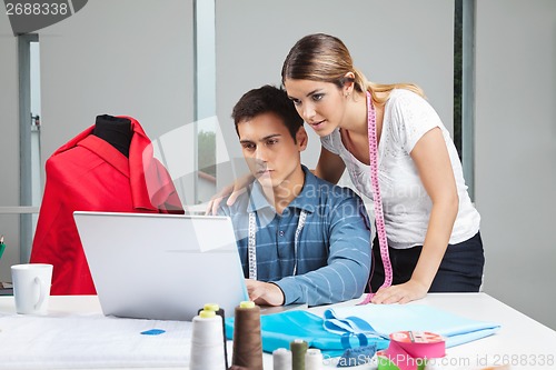 Image of Clothing Designers Working On Laptop