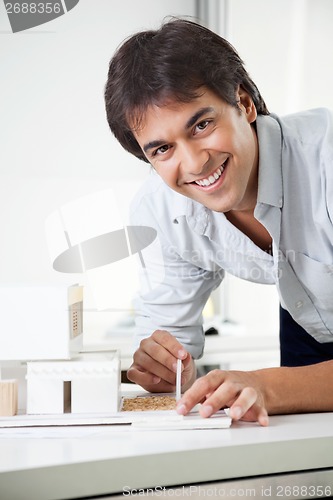 Image of Architect Working On a Model House