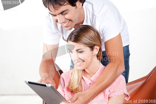Image of Young Couple Using Digital Tablet