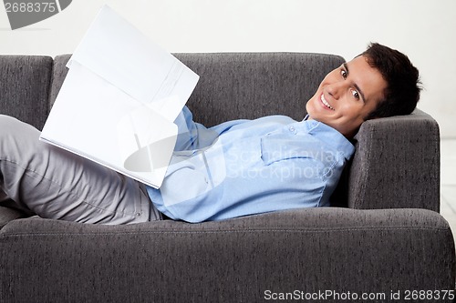 Image of Young Man Holding Magazine