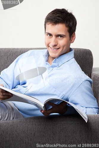 Image of Young Man Holding Magazine