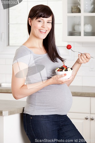 Image of Pregnant Woman Eating Healthy Snack