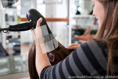 Image of Stylist Drying Woman's Hair