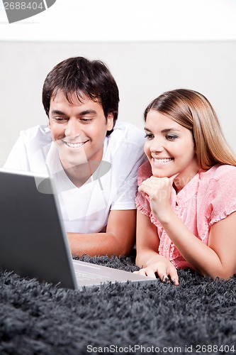 Image of Young Couple Using Laptop