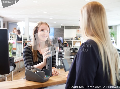 Image of Receptionist and Client in Beauty Salon